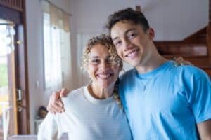 smiling teen and mom after participating in family activities to build trust